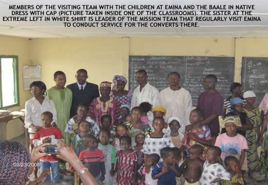 MEMBERS OF THE VISITING TEAM WITH THE CHILDREN AT EMINA AND THE BAALE(PICTURE TAKEN INSIDE ONE OF THE CLASSROOMS).